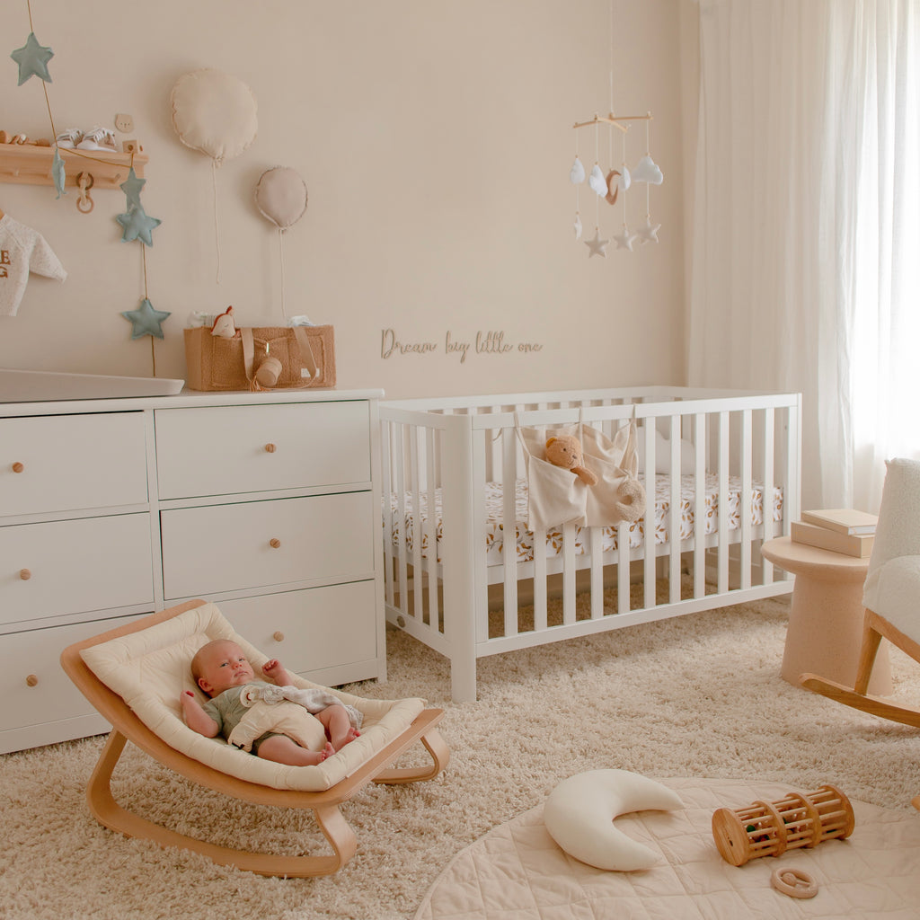 Baby on rocker in decorated baby room