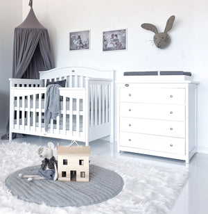 Charcoal coloured canopy hanging over cot in baby room